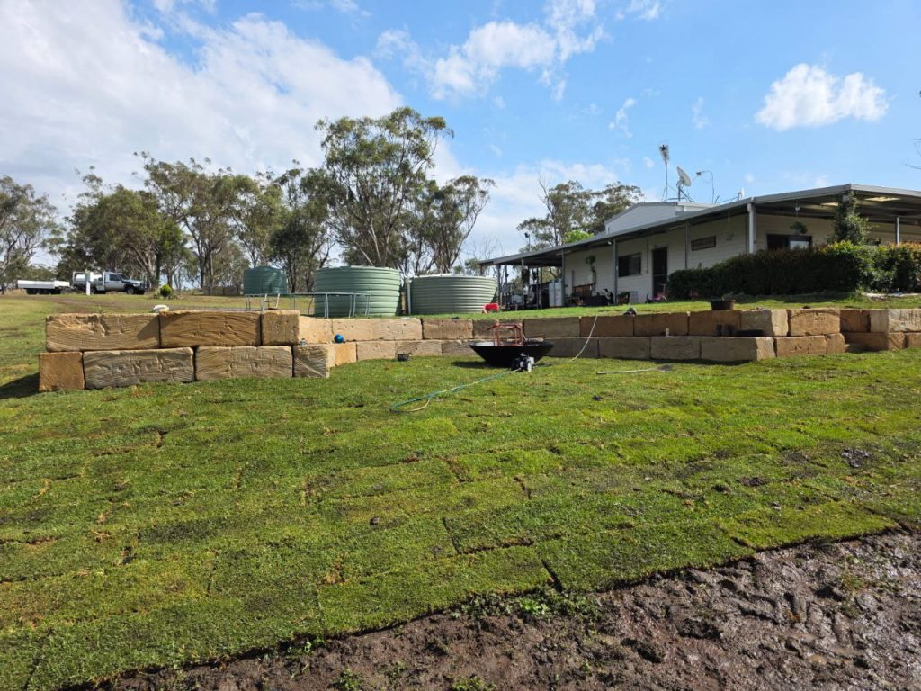 Fresh Eureka Kikuyu PBR turf installed on a residential property in the Southern Downs, prepared for a new roll-out lawn and landscaping project.