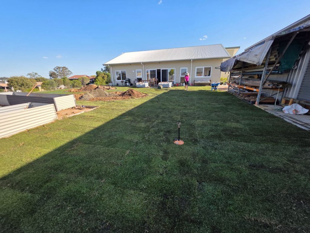 Freshly installed Zoysia Australis instant lawn covering a newly prepared yard, showing even turf coverage after installation.